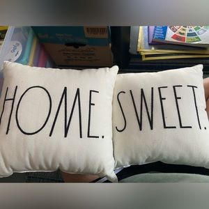 Two Rae Dunn decorative pillows.